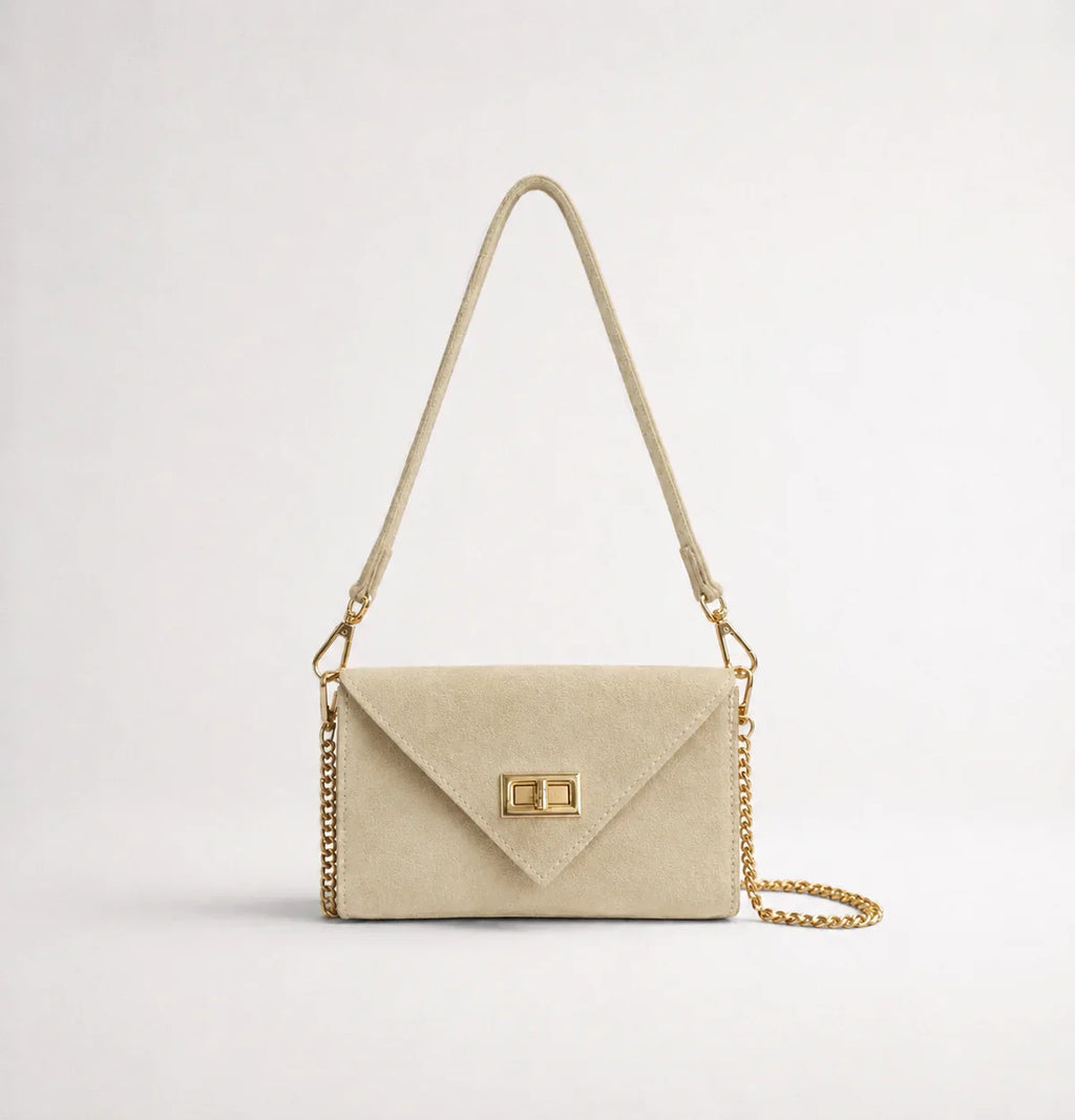 Italian handmade suede occasion bag in cream with gold chain strap, front view showing envelope silhouette and turn-lock clasp