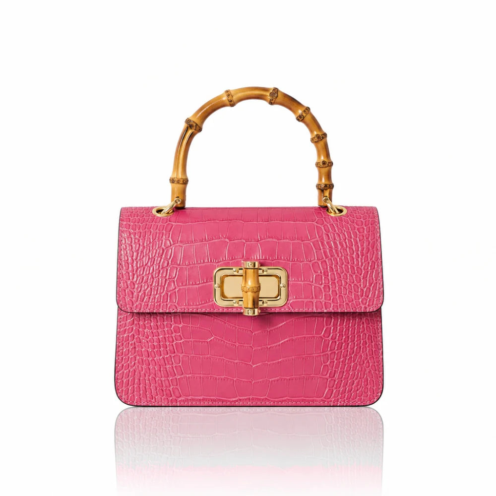 Italian croc-embossed leather bag with curved bamboo handle in fuchsia with gold turn-lock clasp
