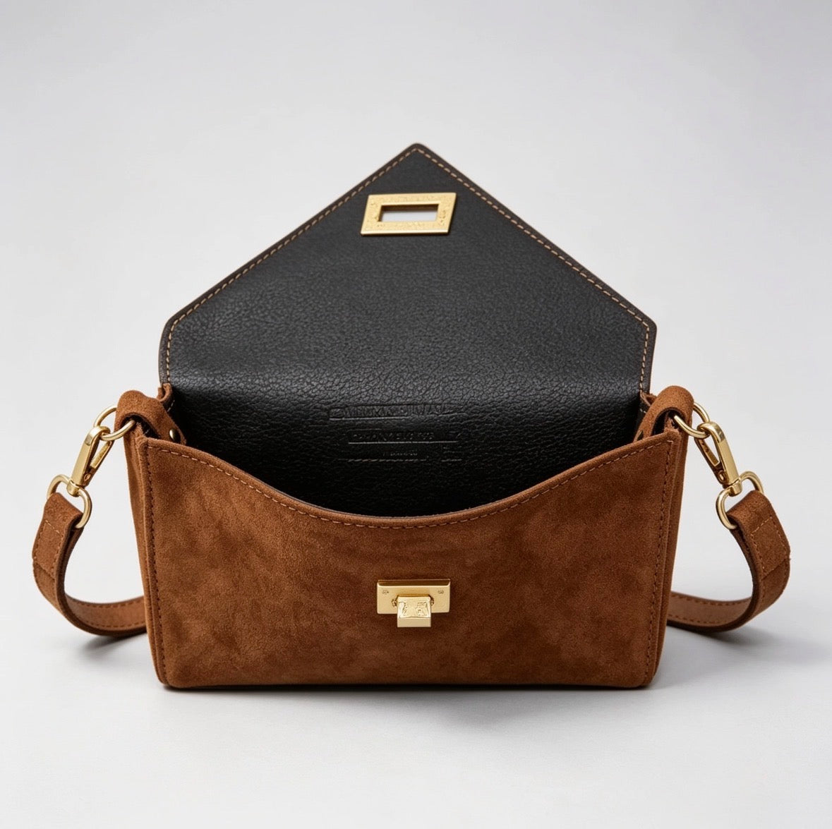 Interior view of Italian handmade suede occasion bag in tan showing black leather lining and gold hardware