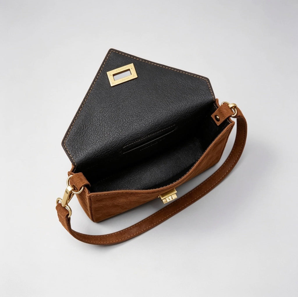 Top-down interior view of Italian handmade suede occasion bag in tan with black leather lining