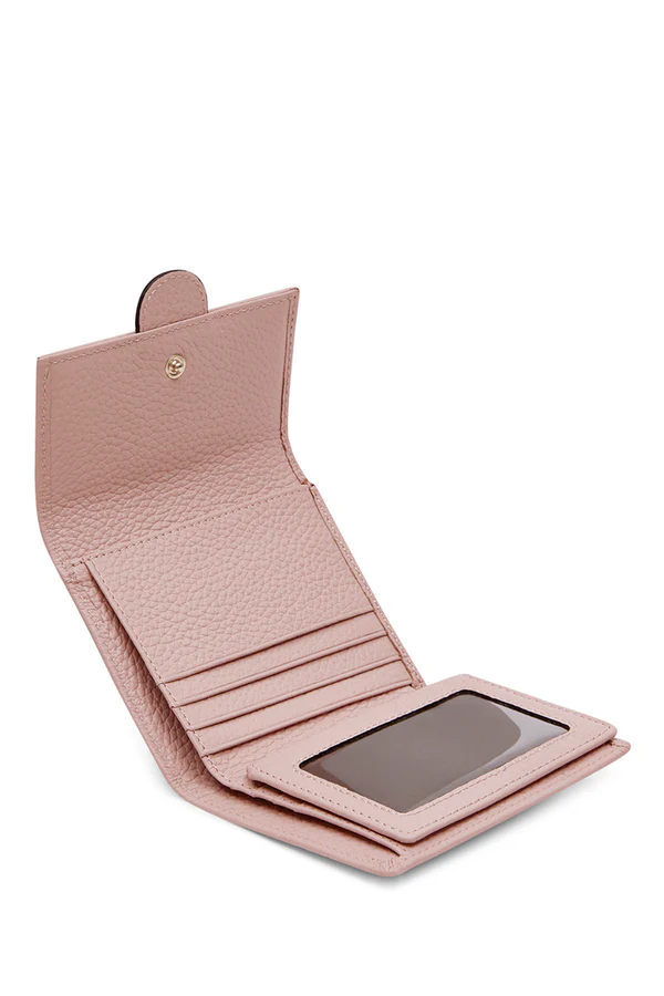 Interior/lifestyle: Interior view of pink croc-embossed Italian leather compact trifold wallet showing card slots and clear ID window, handmade in Italy | MERLEORA